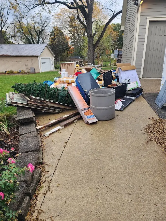 Dumpster being loaded with debris for Estate Cleanout Dumpster Rental in South Charleston